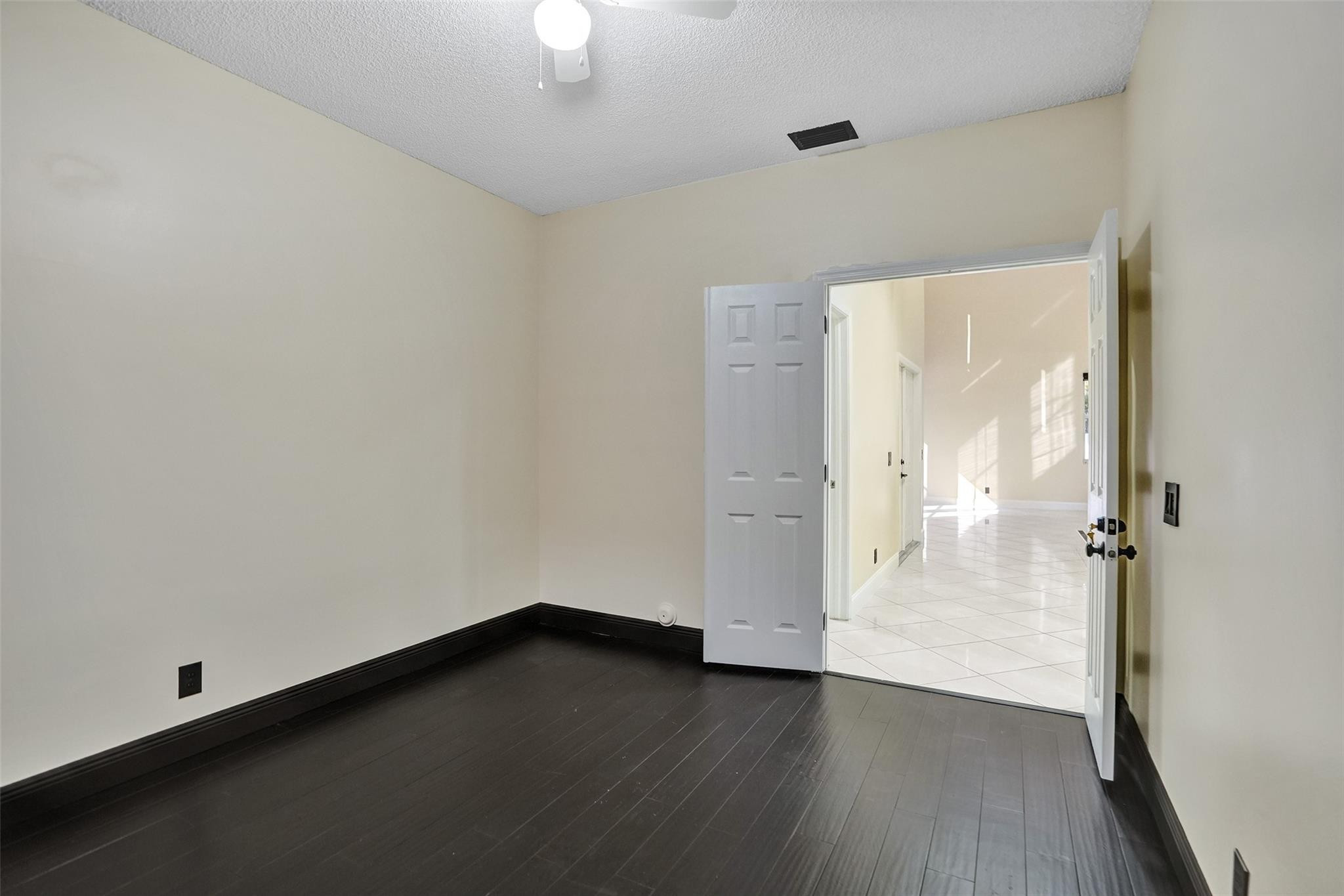 574 Slippery Rock Road Weston, FL 33327 - Photo 33 of 64 an empty room with wooden floor