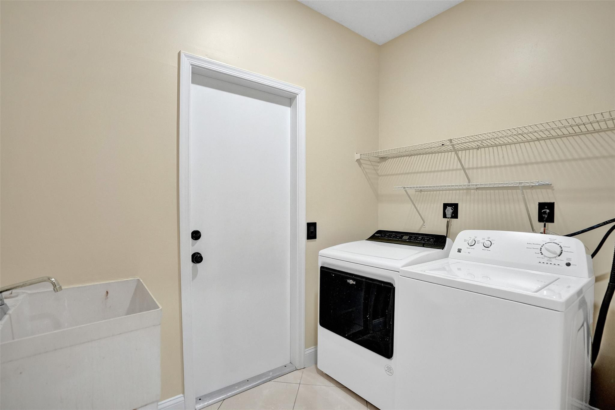 574 Slippery Rock Road Weston, FL 33327 - Photo 34 of 64 a utility room with dryer and washer