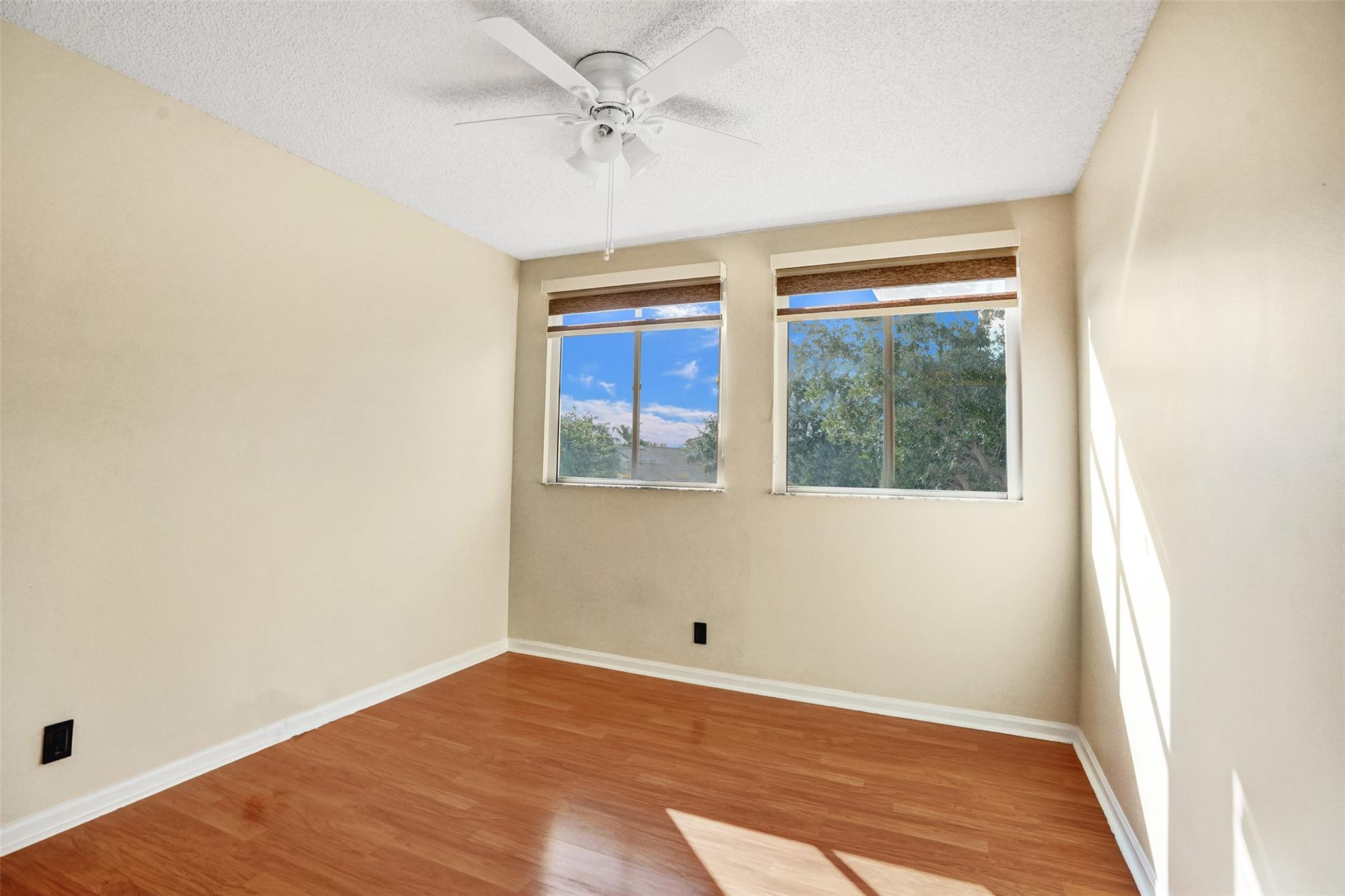 574 Slippery Rock Road Weston, FL 33327 - Photo 35 of 64 a view of an empty room with wooden floor and a window