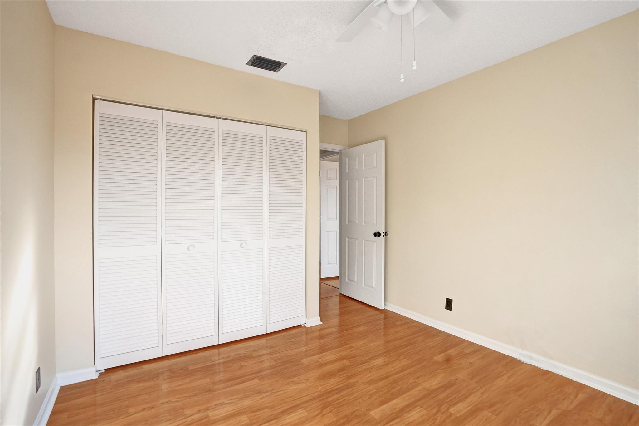 574 Slippery Rock Road Weston, FL 33327 - Photo 36 of 64 a view of an empty room with wooden floor