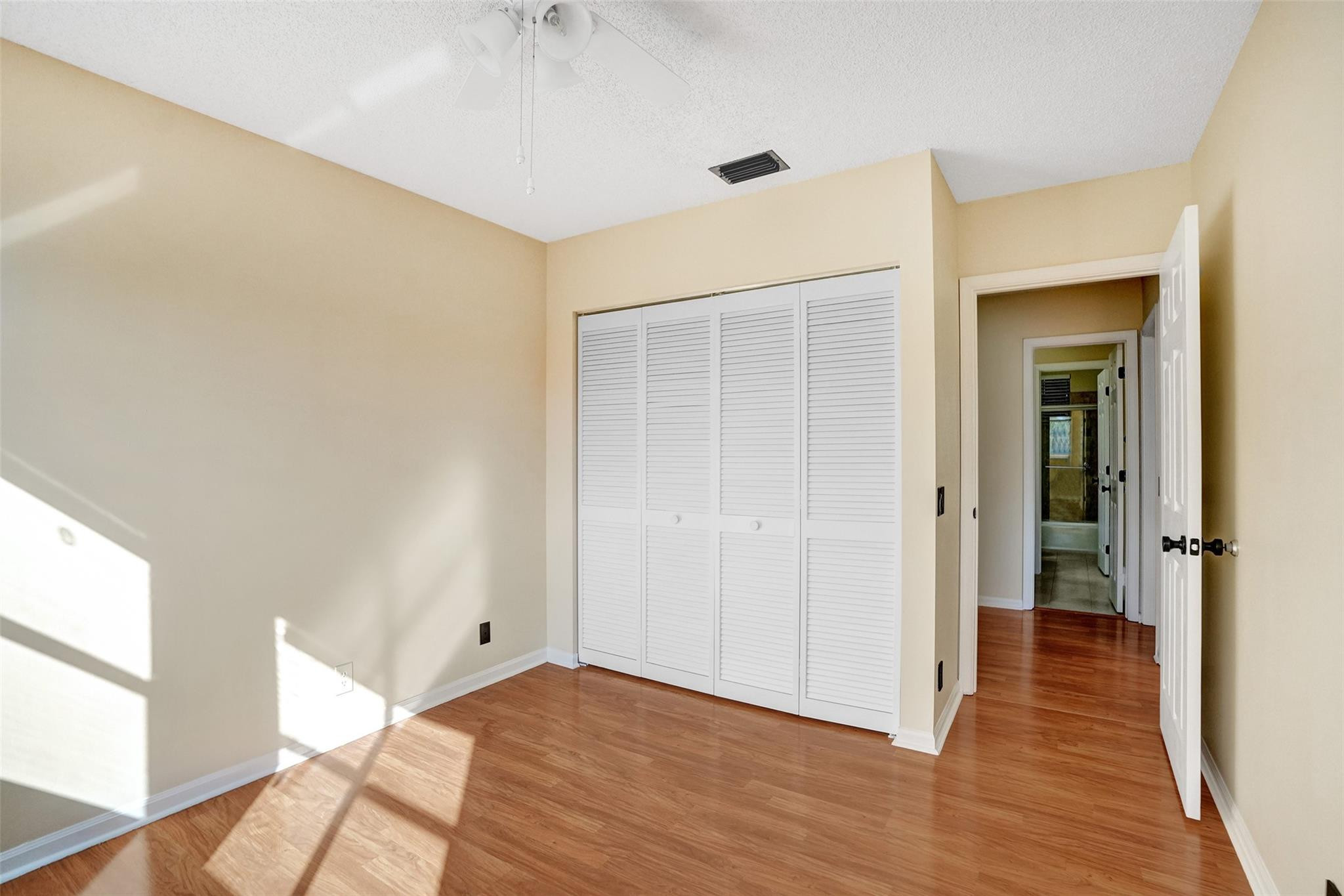 574 Slippery Rock Road Weston, FL 33327 - Photo 37 of 64 a view of an empty room with wooden floor