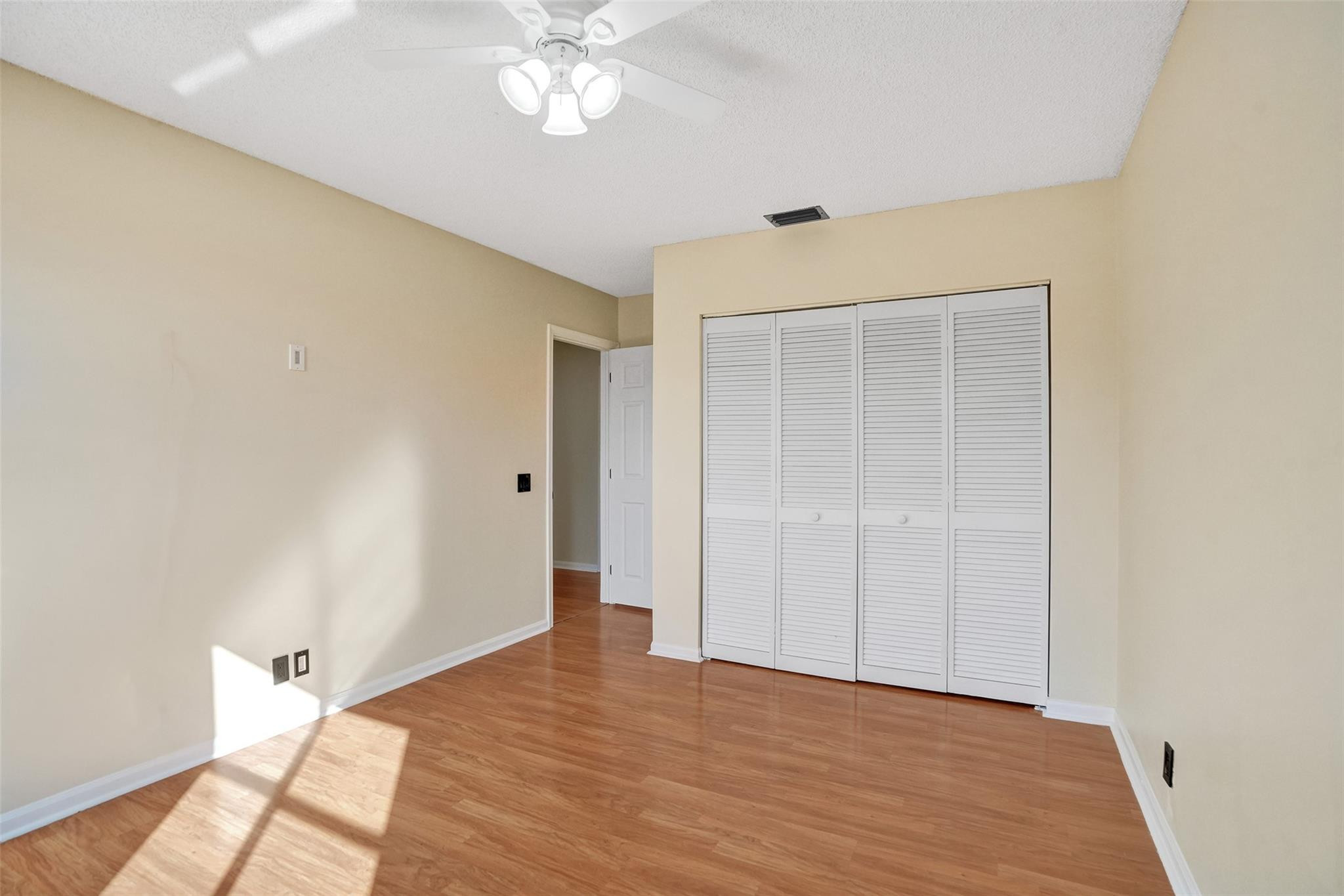 574 Slippery Rock Road Weston, FL 33327 - Photo 40 of 64 a view of an empty room with wooden floor