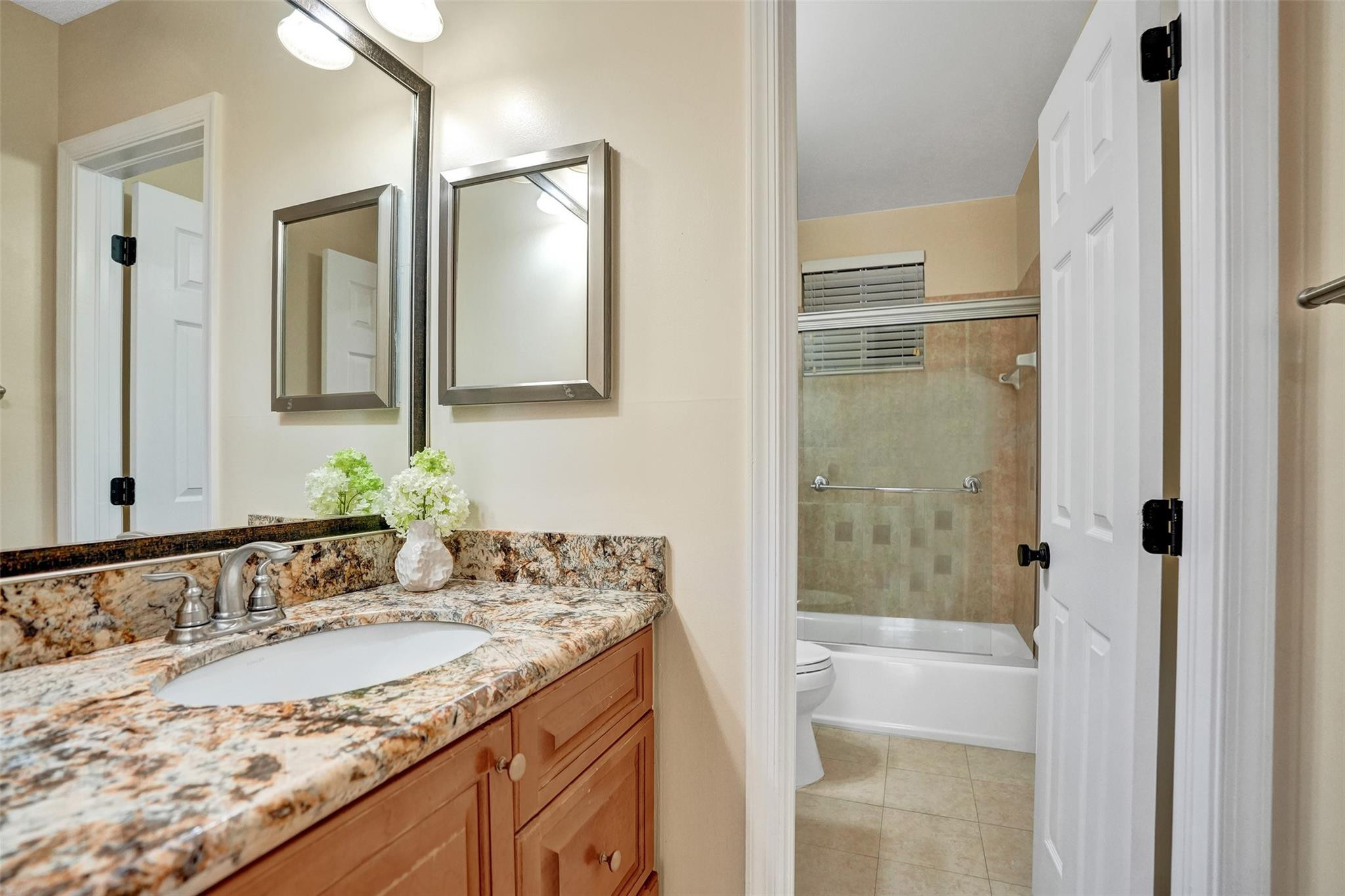 574 Slippery Rock Road Weston, FL 33327 - Photo 46 of 64 a bathroom with a granite countertop sink and a mirror