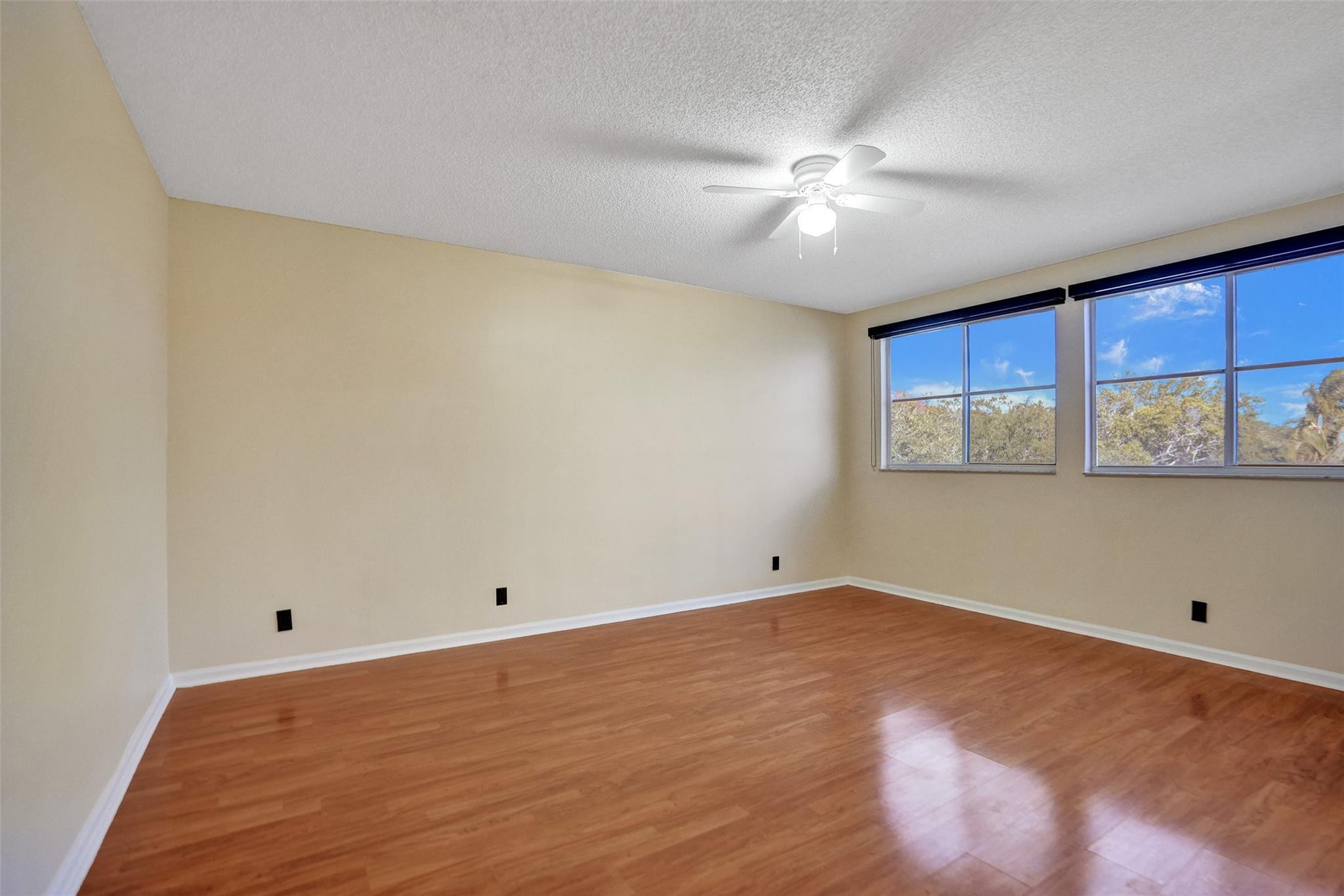 574 Slippery Rock Road Weston, FL 33327 - Photo 48 of 64 a view of an empty room with window and wooden floor