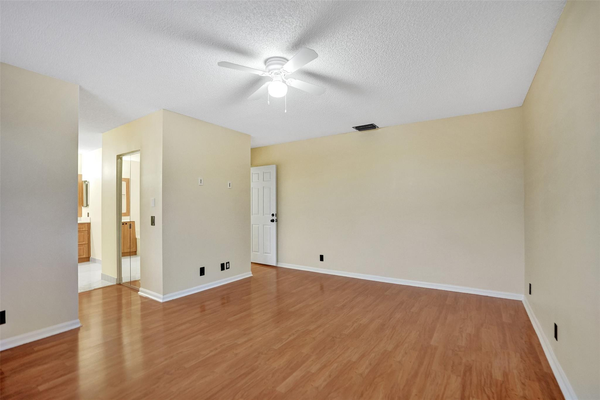 574 Slippery Rock Road Weston, FL 33327 - Photo 51 of 64 an empty room with wooden floor and fan