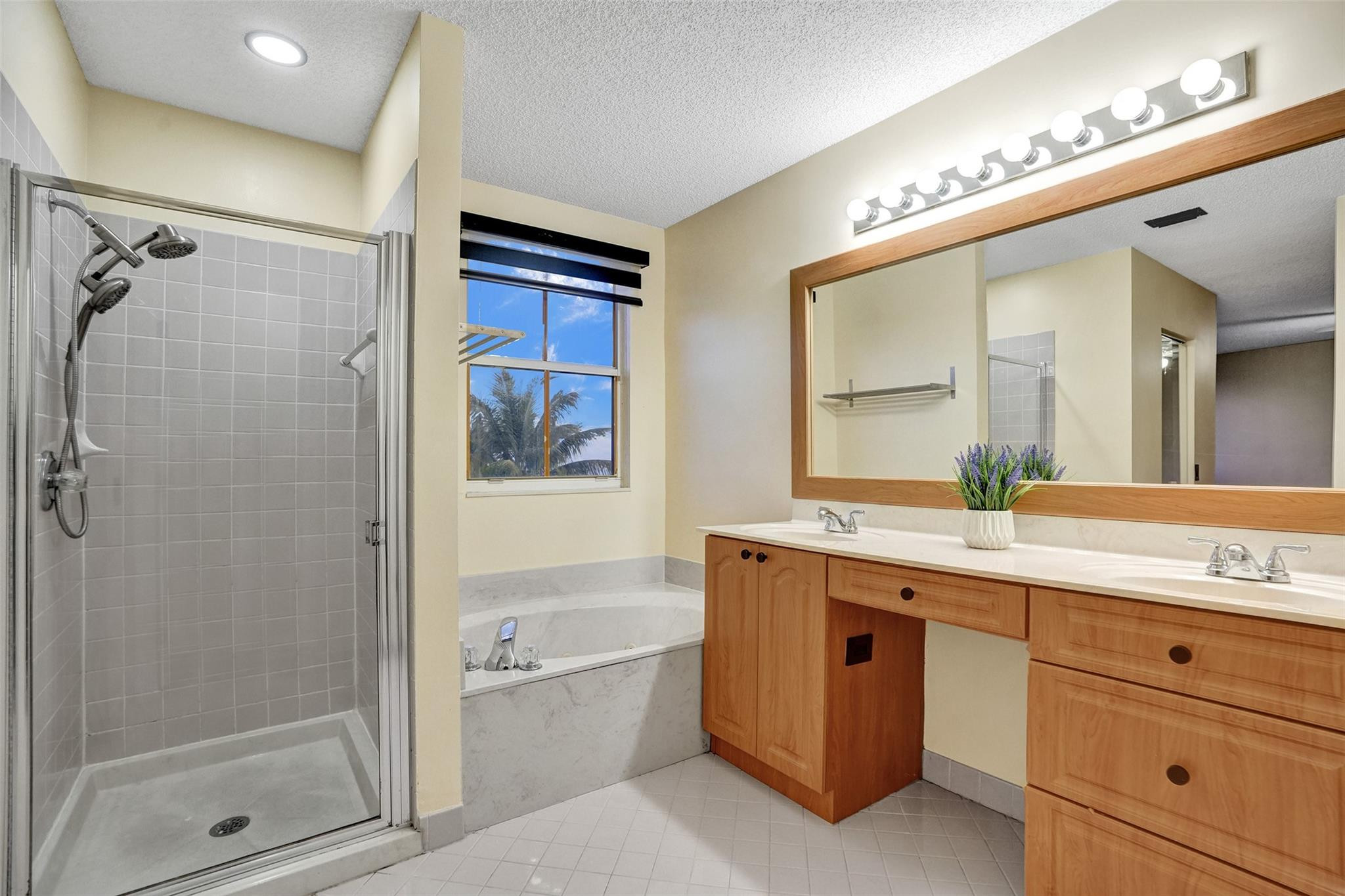 574 Slippery Rock Road Weston, FL 33327 - Photo 54 of 64 a bathroom with a granite countertop sink mirror bathtub and shower