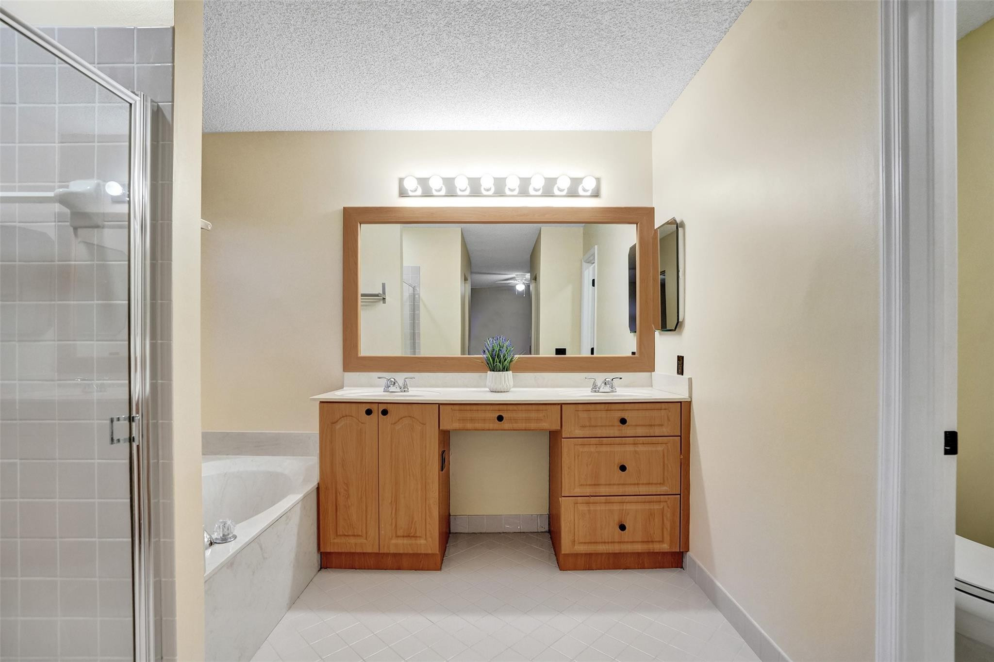 574 Slippery Rock Road Weston, FL 33327 - Photo 55 of 64 a bathroom with a granite countertop sink mirror and a bathtub