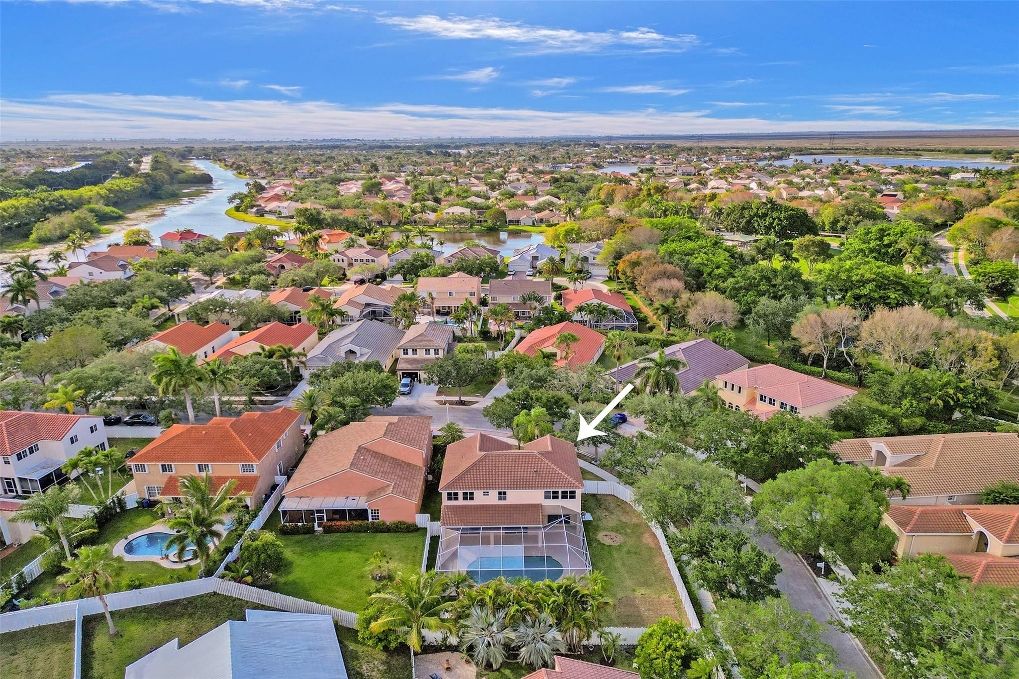 574 Slippery Rock Road Weston, FL 33327 - Photo 63 of 64 an aerial view of a city with lots of residential buildings ocean and mountain view in back