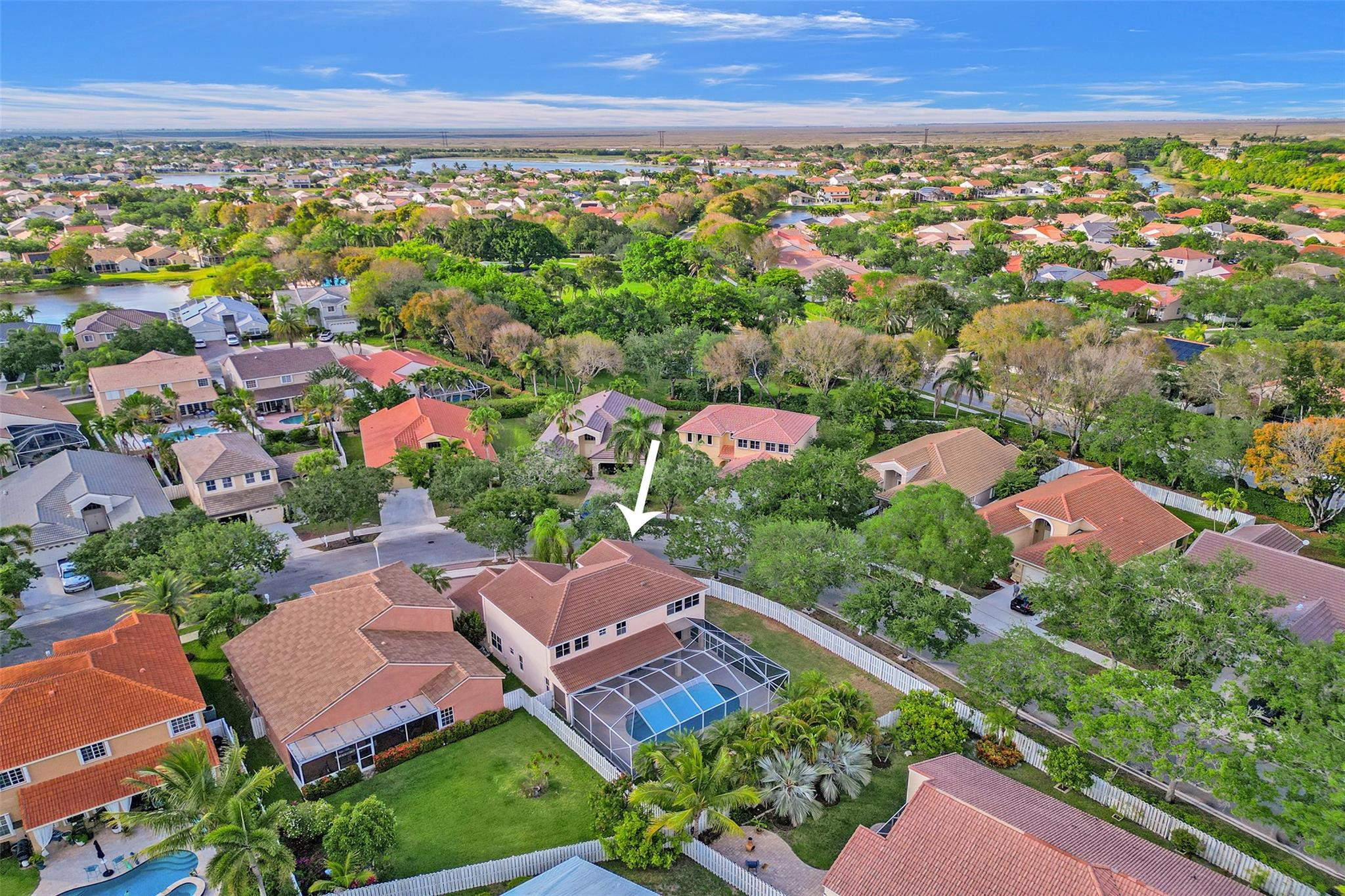 574 Slippery Rock Road Weston, FL 33327 - Photo 64 of 64 an aerial view of a city with lots of residential buildings ocean and mountain view in back