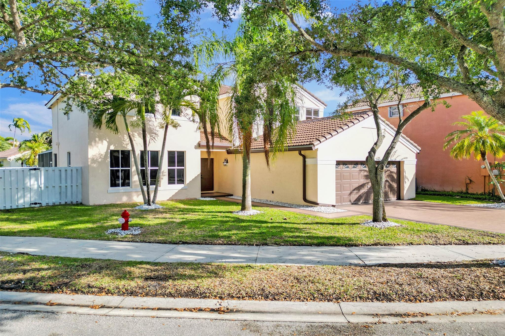 574 Slippery Rock Road Weston, FL 33327 - Photo 8 of 64 a house with trees in front of it