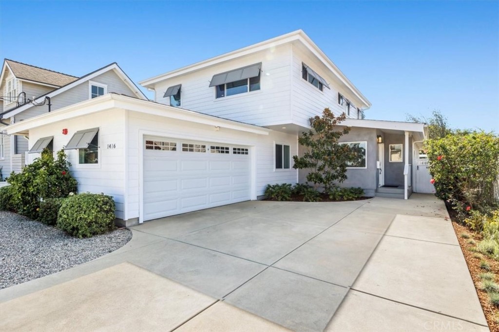 a front view of a house with plants
