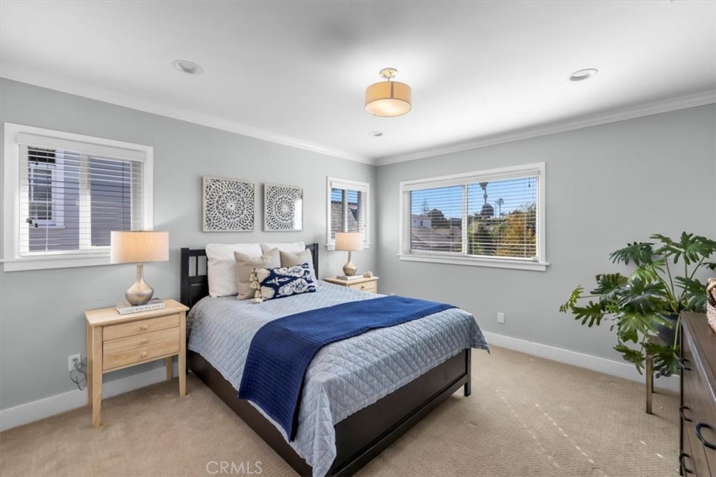 1416 11th Street Manhattan Beach, CA 90266 - Photo 18 of 28 a bedroom with bed and a potted plant