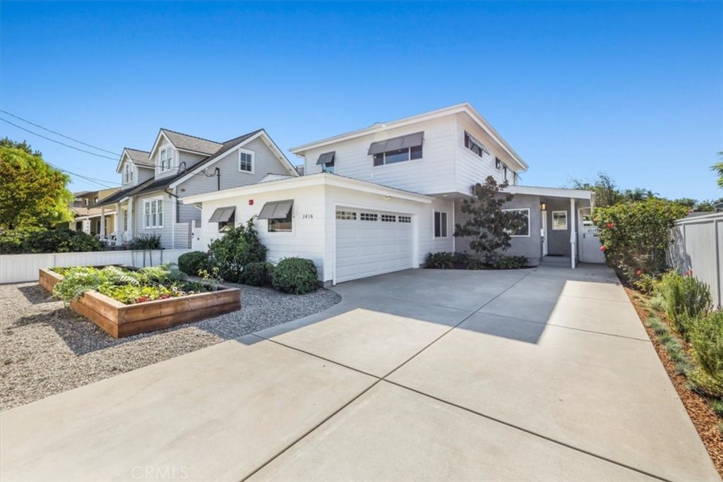 1416 11th Street Manhattan Beach, CA 90266 - Photo 2 of 28 a front view of a house with garden
