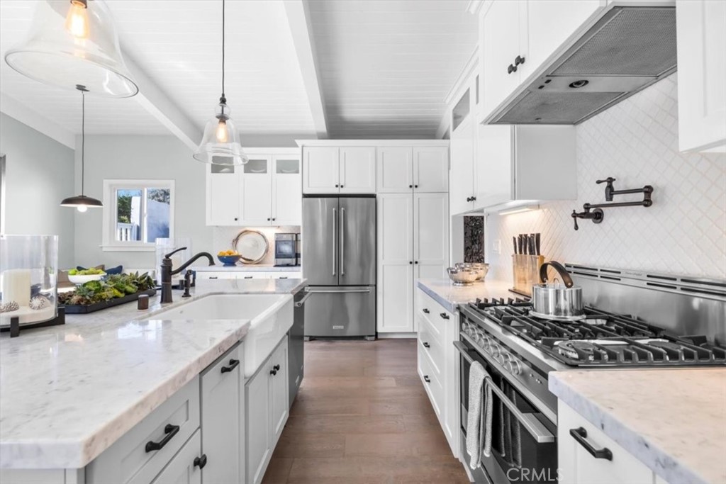 1416 11th Street Manhattan Beach, CA 90266 - Photo 5 of 28 a kitchen with stainless steel appliances a sink stove and refrigerator
