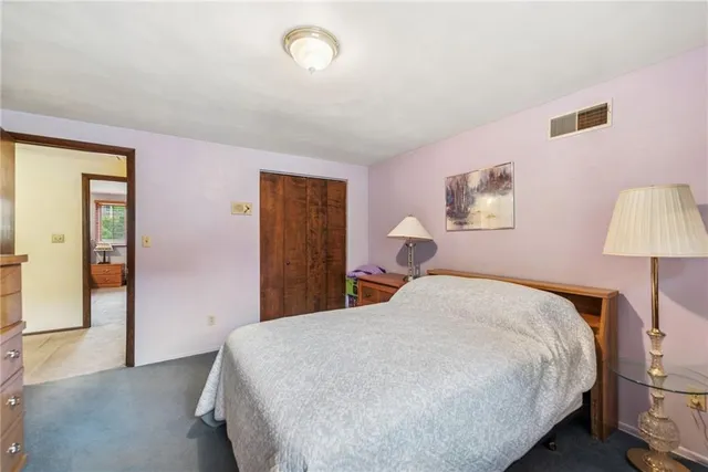 a bedroom with a bed and a lamp