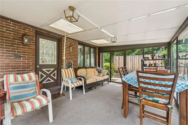 a bedroom with furniture and a large window