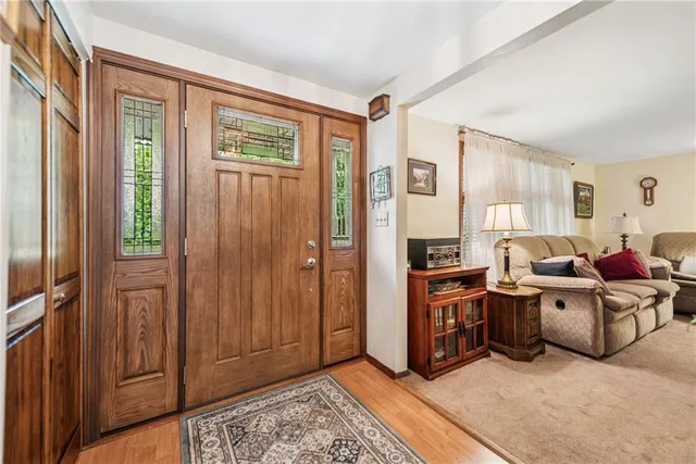 a living room with furniture a window and a flat screen tv