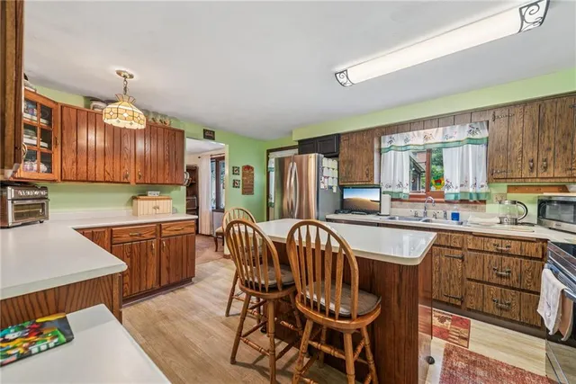 a kitchen with a table chairs sink and cabinets