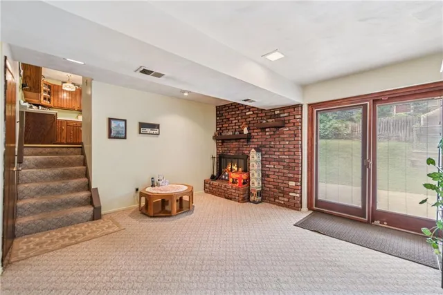 a view of a livingroom with furniture and staircase