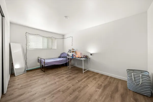 a bedroom with furniture and a window