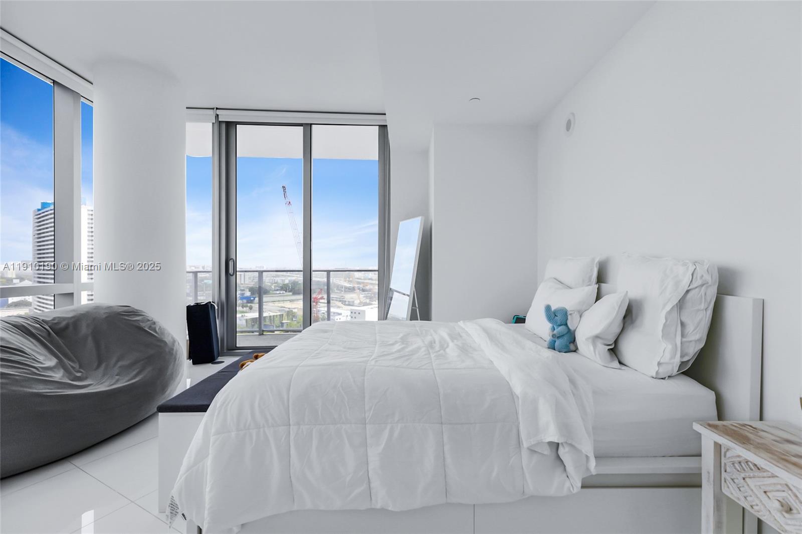 851 Northeast 1st Avenue, Unit 1202 Miami, FL 33132 - Photo 14 of 29 a bedroom with a bed and window