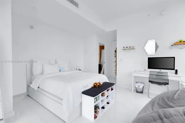 a bedroom with a bed and a flat screen tv