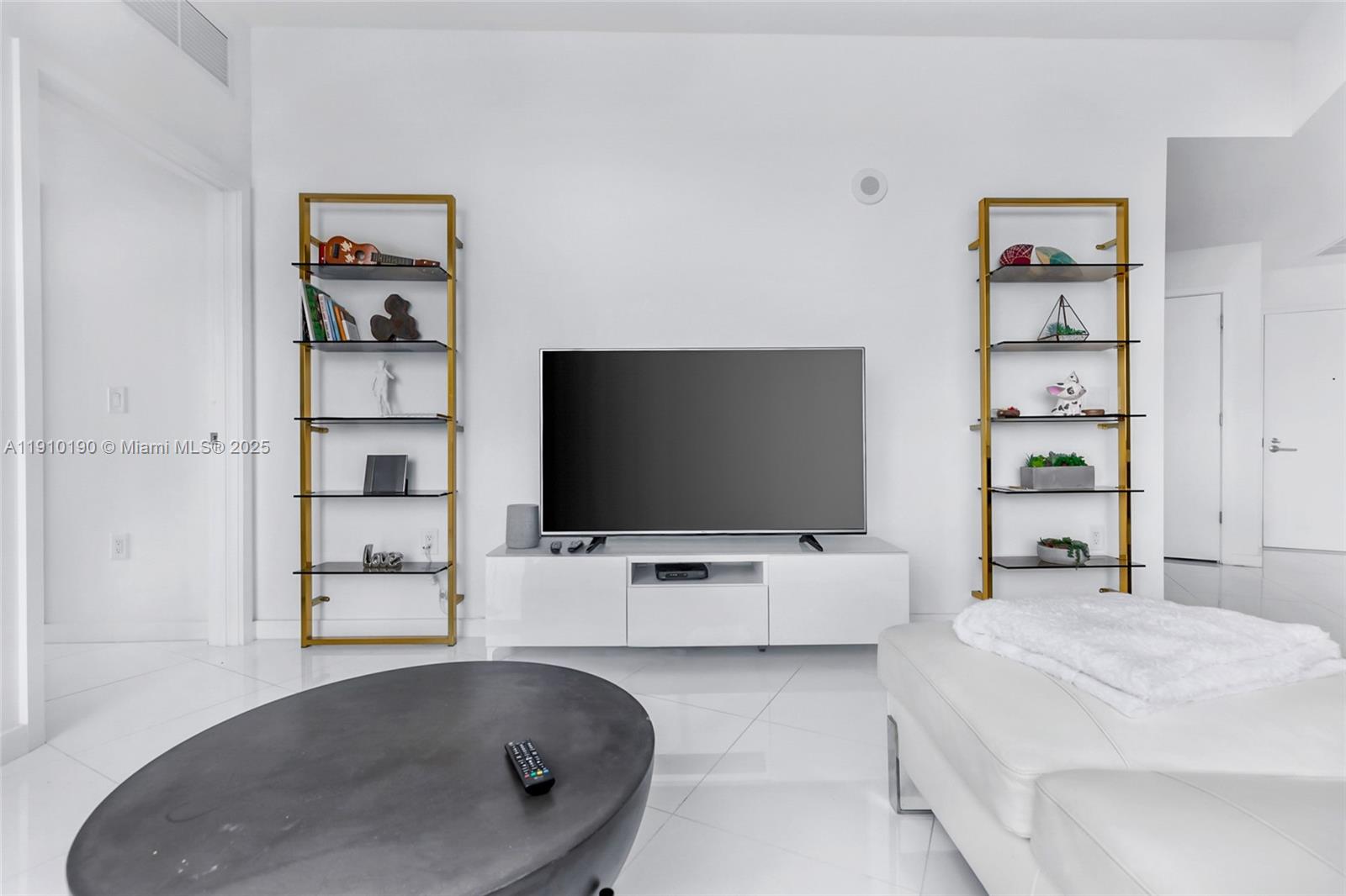 851 Northeast 1st Avenue, Unit 1202 Miami, FL 33132 - Photo 10 of 29 a living room with furniture and a flat screen tv