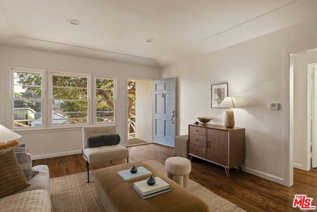 a bedroom with a bed and a potted plant