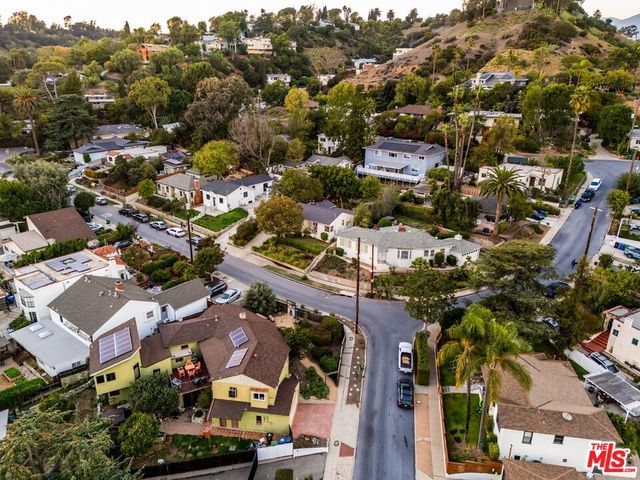 an aerial view of residential houses with outdoor space