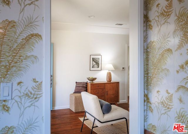 a kitchen with a sink cabinets and wooden floor