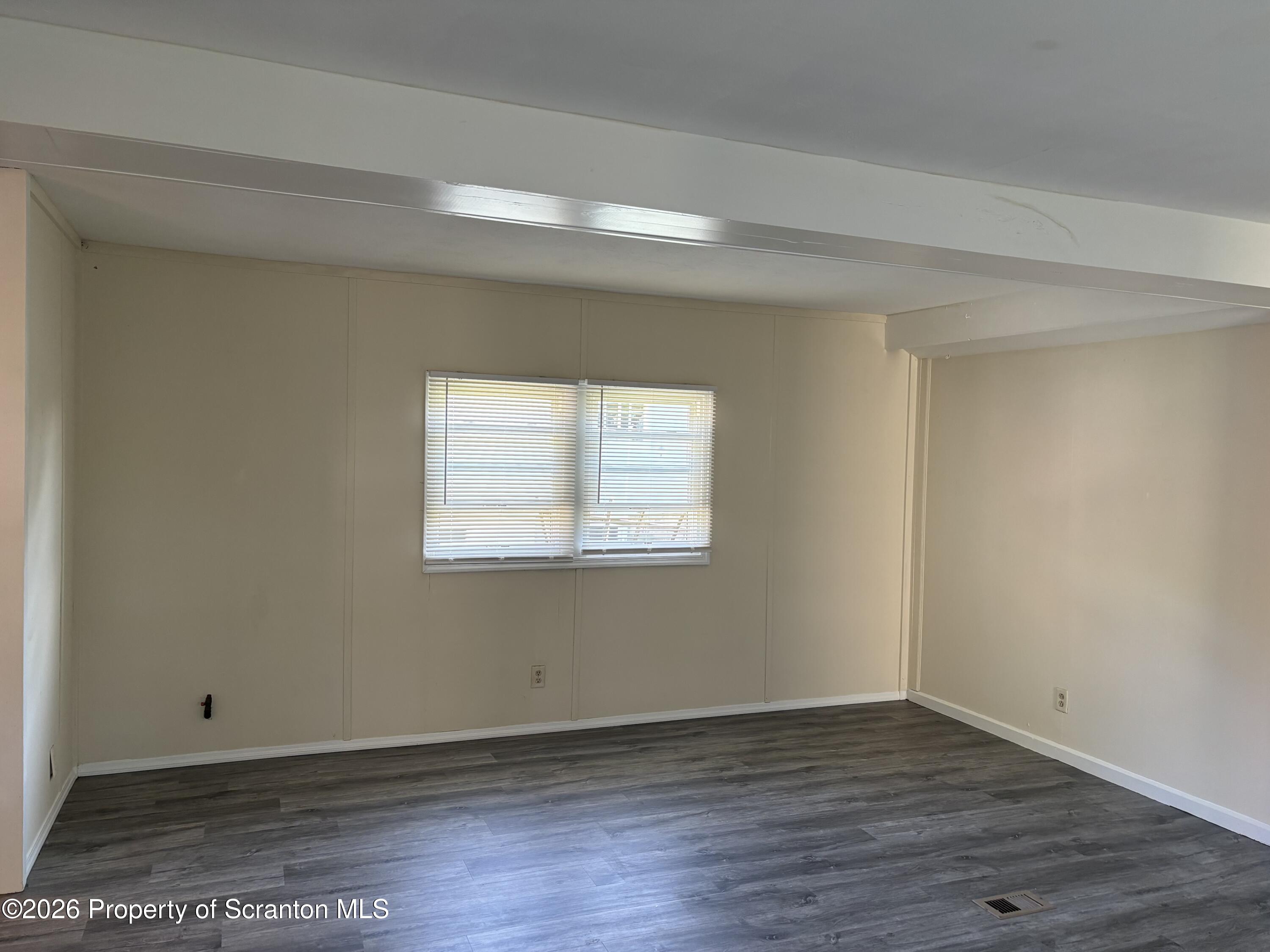 146 6th Street Blakely, PA 18447 - Photo 16 of 24 an empty room with wooden floor and windows