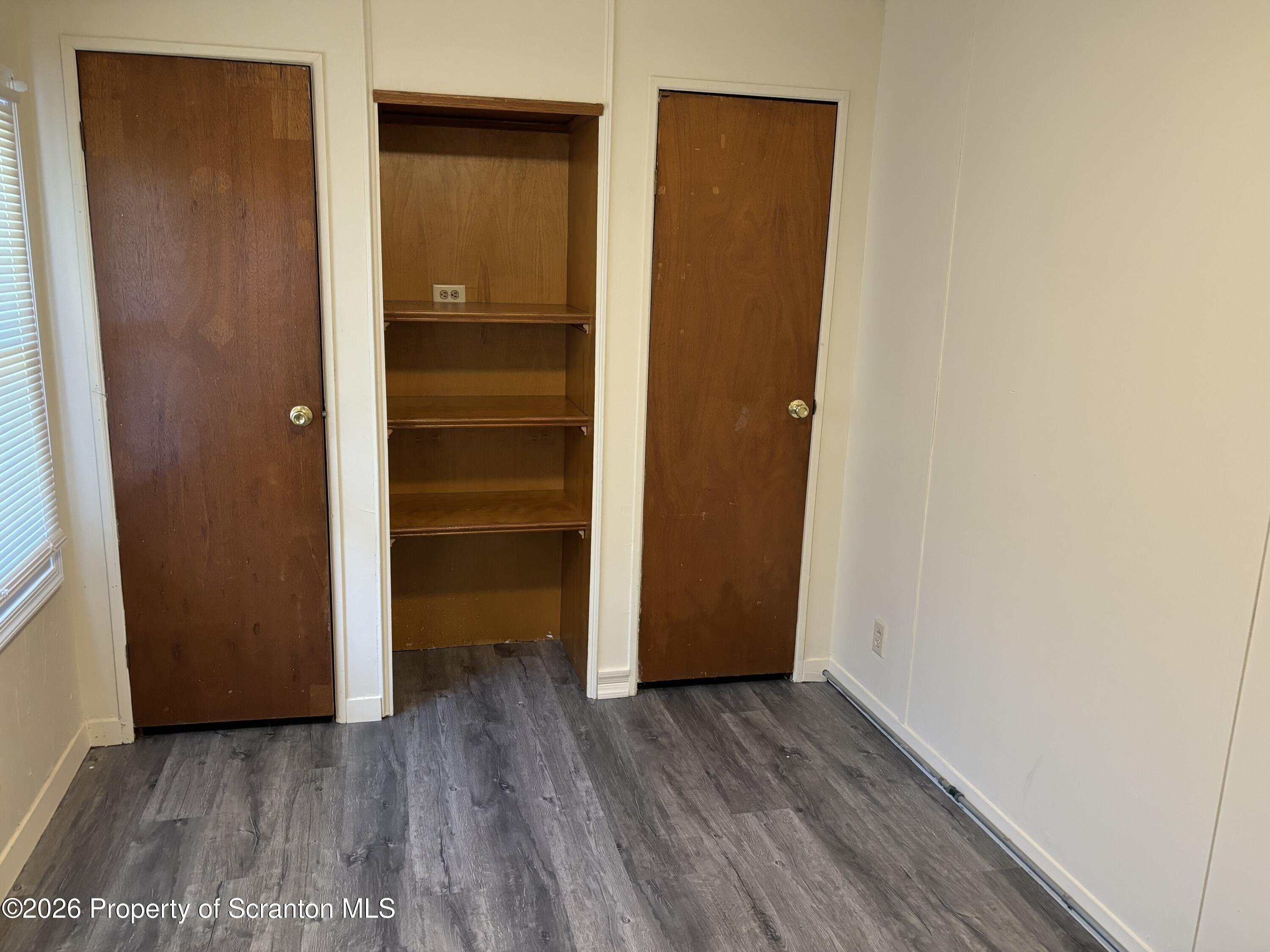 146 6th Street Blakely, PA 18447 - Photo 20 of 24 a view of walk in closet with wooden floor