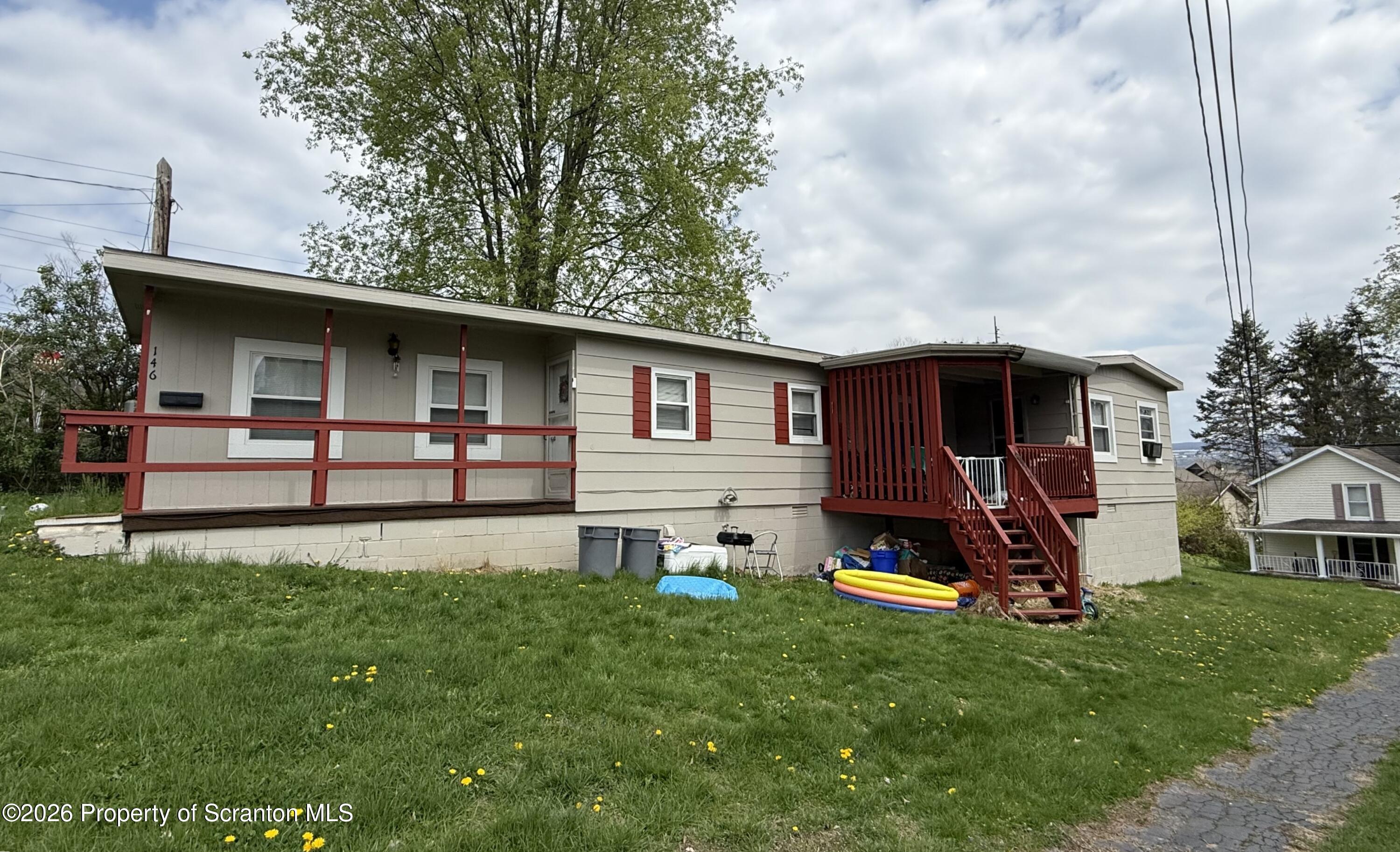 146 6th Street Blakely, PA 18447 - Photo 2 of 24 a view of a backyard with table and chairs and wooden fence