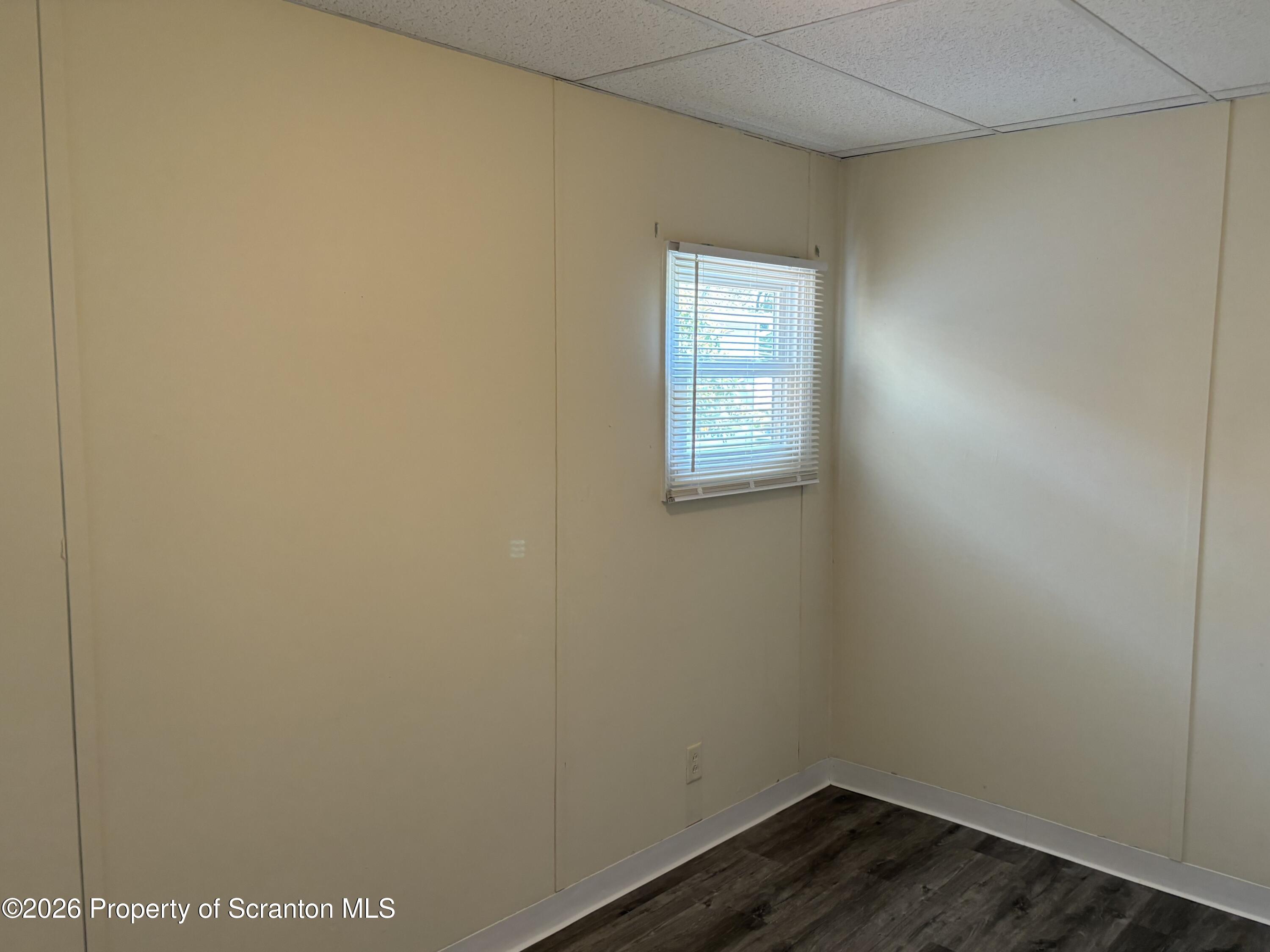 146 6th Street Blakely, PA 18447 - Photo 21 of 24 a view of an empty room with wooden floor and a window