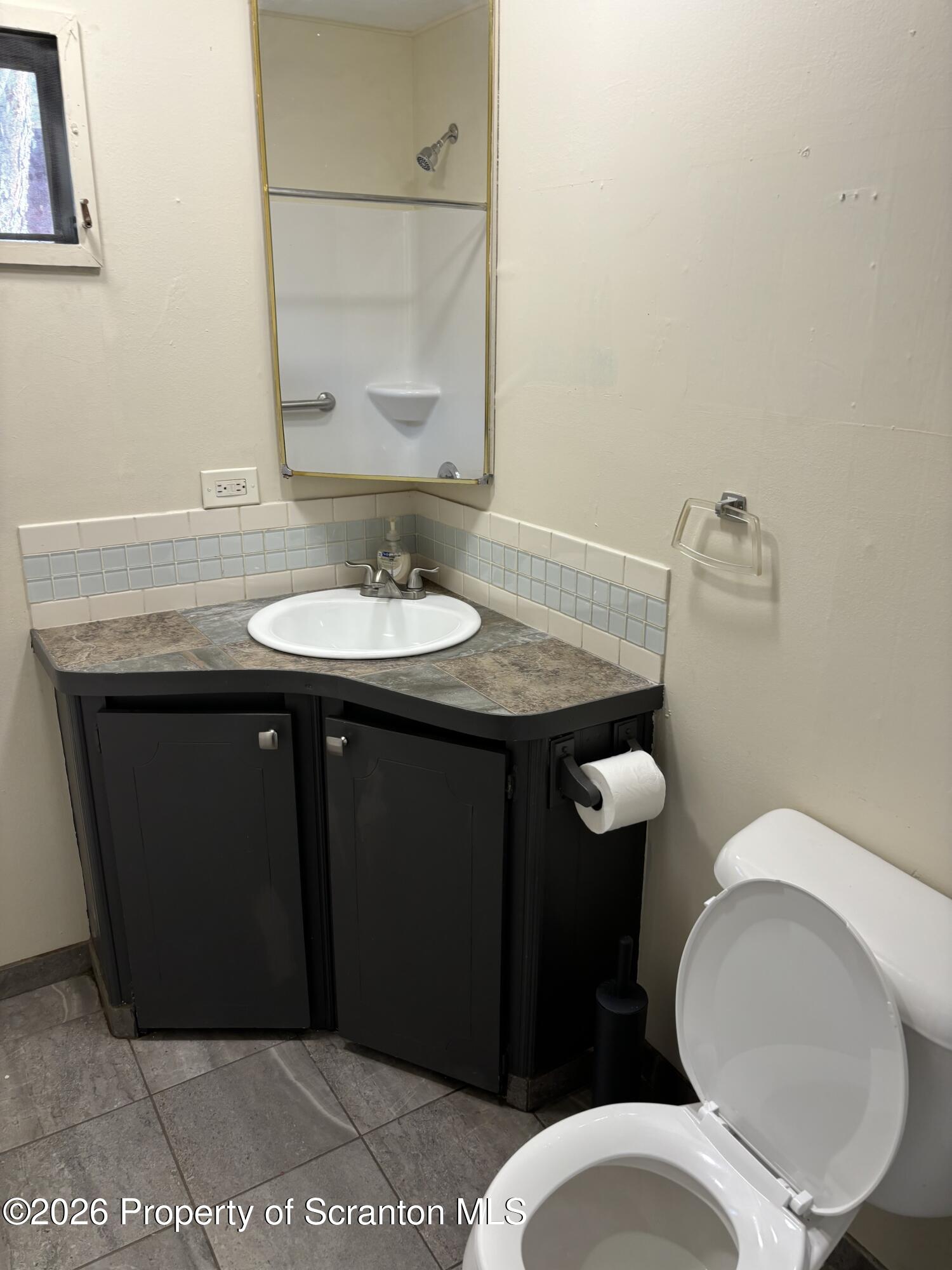 146 6th Street Blakely, PA 18447 - Photo 22 of 24 a bathroom with a granite countertop toilet sink and mirror