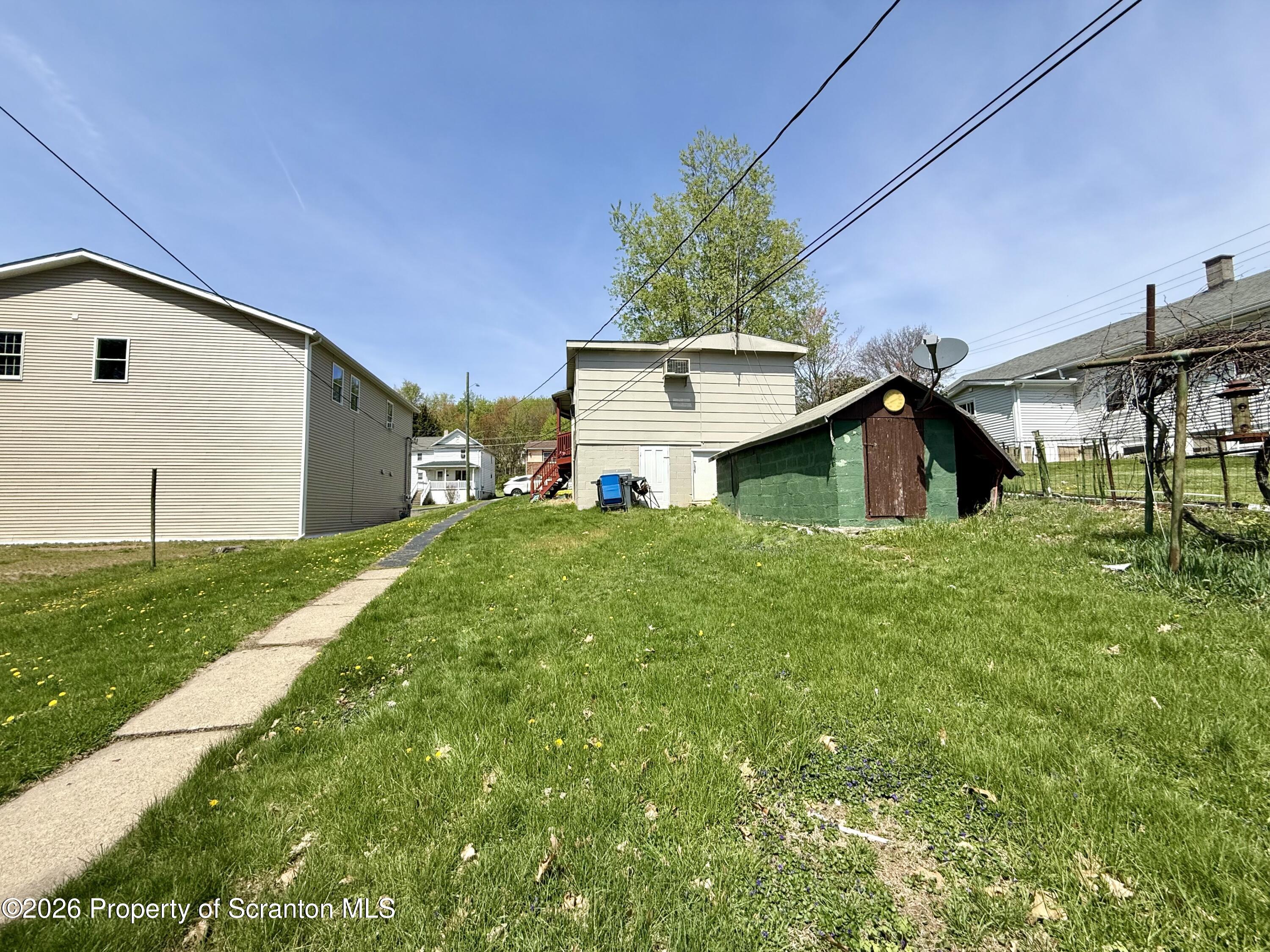 146 6th Street Blakely, PA 18447 - Photo 3 of 24 a view of a house with a yard