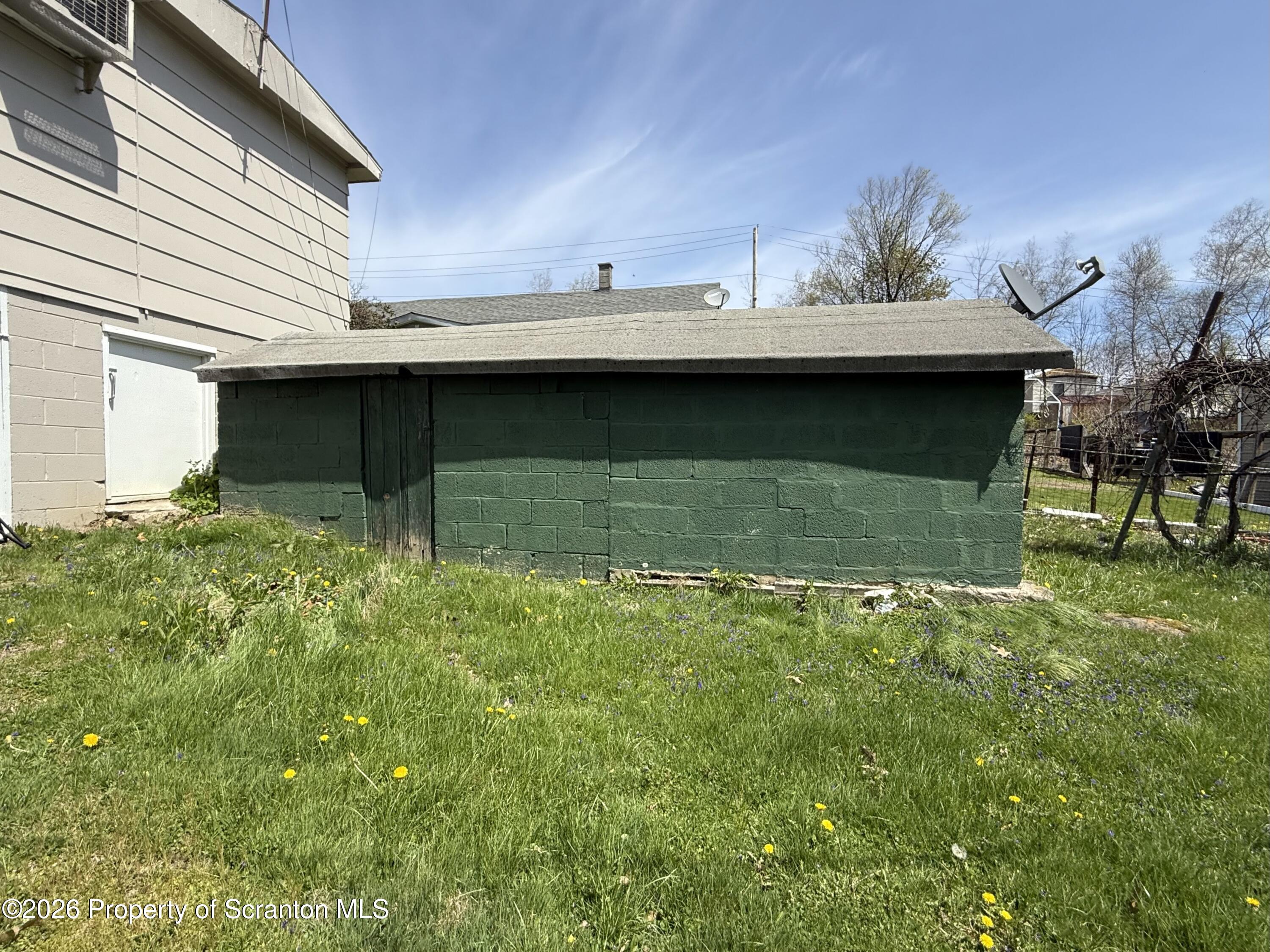 146 6th Street Blakely, PA 18447 - Photo 4 of 24 a view of a backyard with plants and a patio