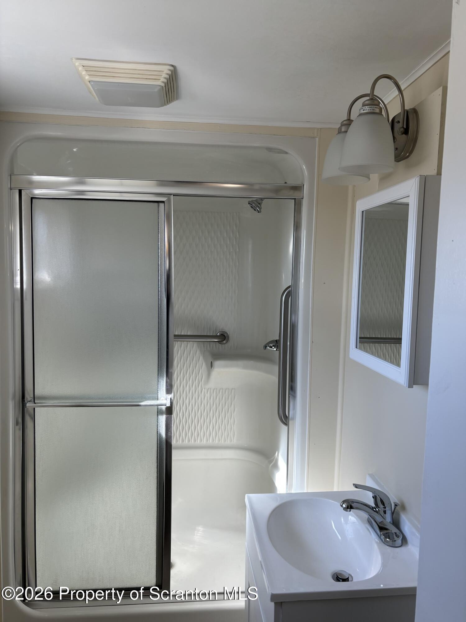146 6th Street Blakely, PA 18447 - Photo 9 of 24 a bathroom with a sink and a mirror