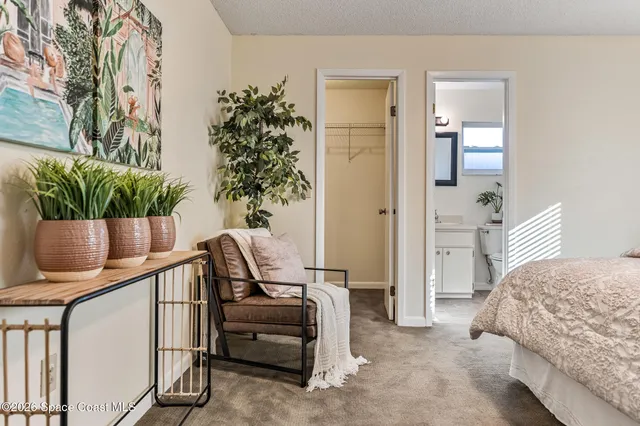 a bedroom with furniture and a potted plant