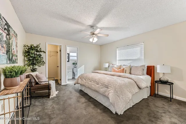 a spacious bedroom with a bed and a couch