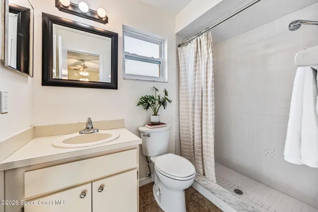 a bathroom with a sink mirror vanity and toilet
