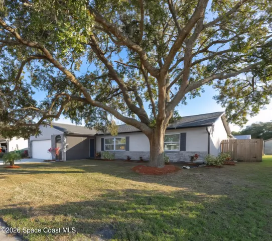 a house that has a tree in front of it
