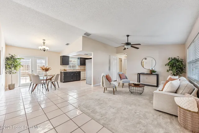 a living room with furniture a dining table and a fireplace