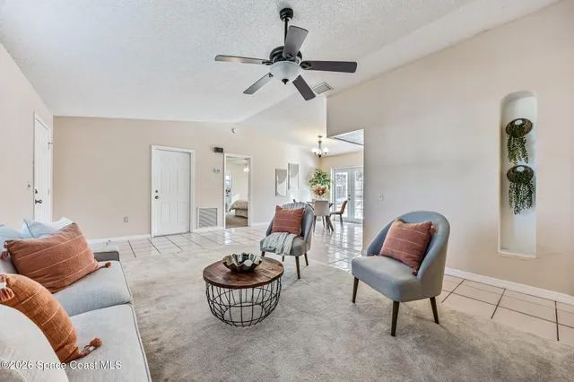 a living room with furniture and a potted plant