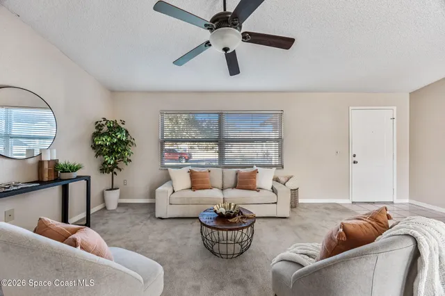 a living room with furniture and a large window