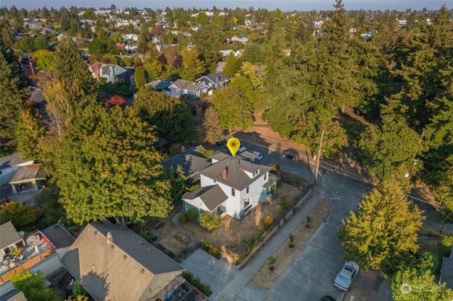 an aerial view of a house with a yard