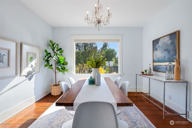 a living room with furniture a large window and a chandelier