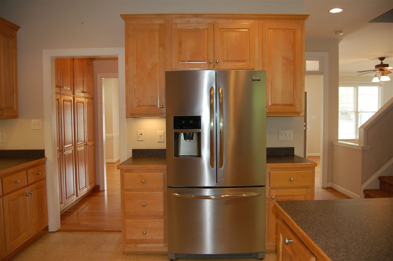 840 Nowell Ridge Road Raleigh, NC 27607 - Photo 8 of 25 View of back side of Kitchen looking back towards Butler's Pantry on one side & guest bath where door is, stairs & LR on right! Kitchen
