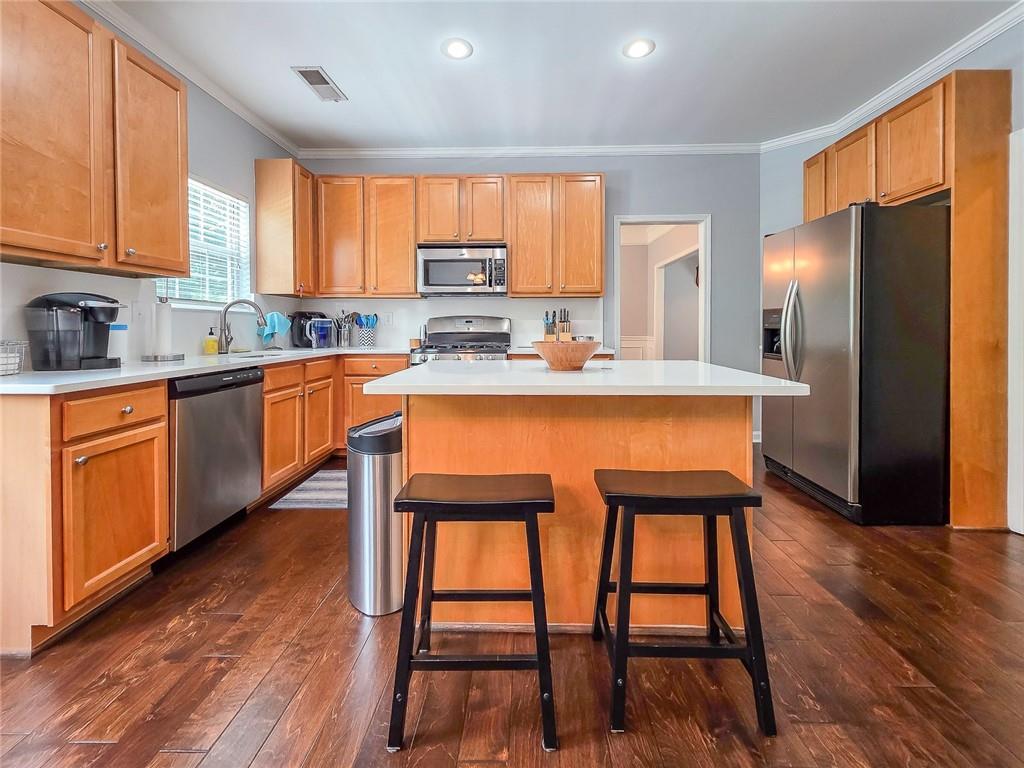 43 Ivy Mist Lane Acworth, GA 30101 - Photo 8 of 58 a kitchen with stainless steel appliances granite countertop wooden floor dining table and chairs