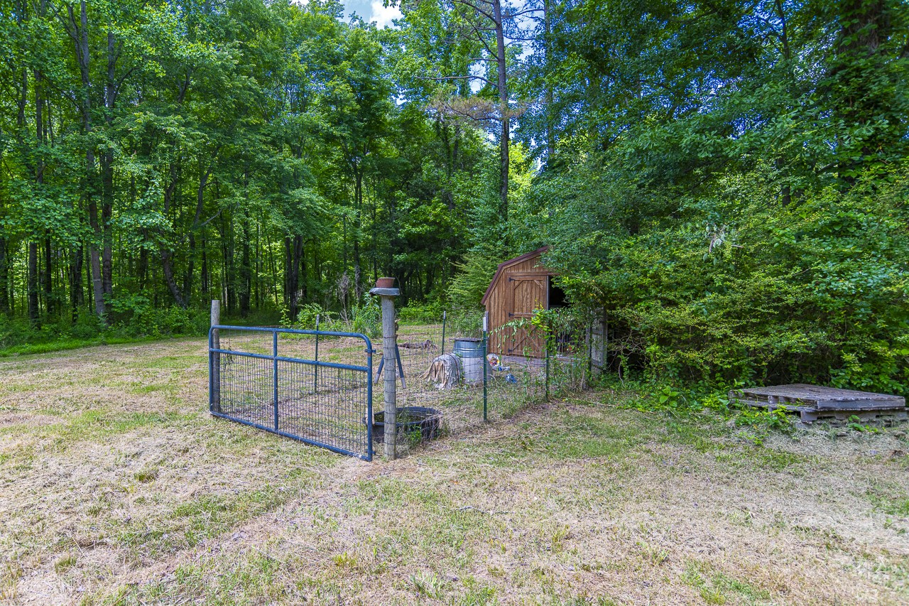 23 Grassy Branch Road Flintville, TN 37335 - Photo 7 of 24 a backyard of a house with childrens swings and slides